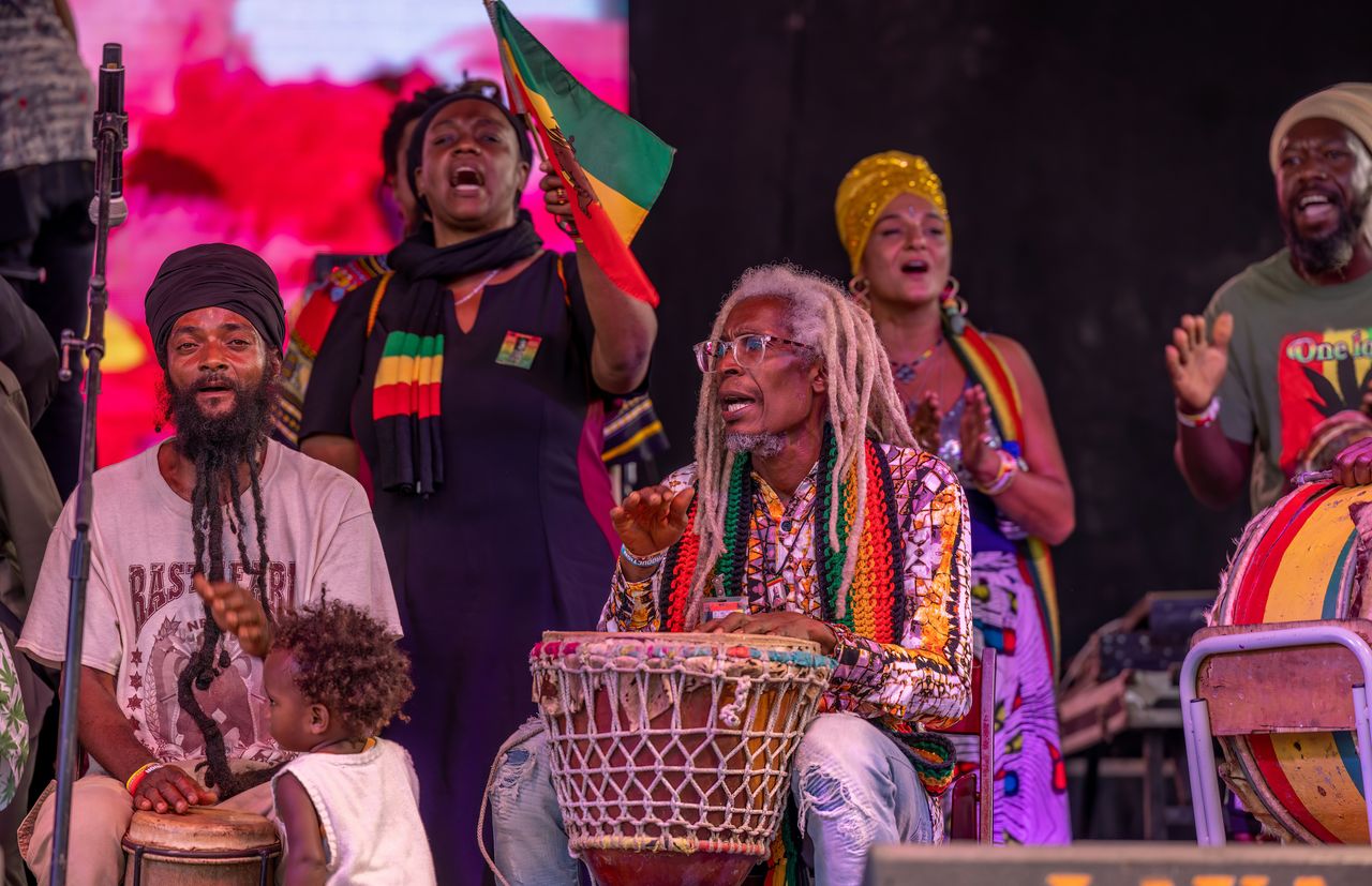 Women performing reggae music in Trench Town, reflecting feminine resilience and artistry.